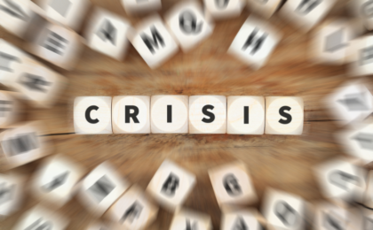 Image of lots of dice blurred and spelling out the word crisis